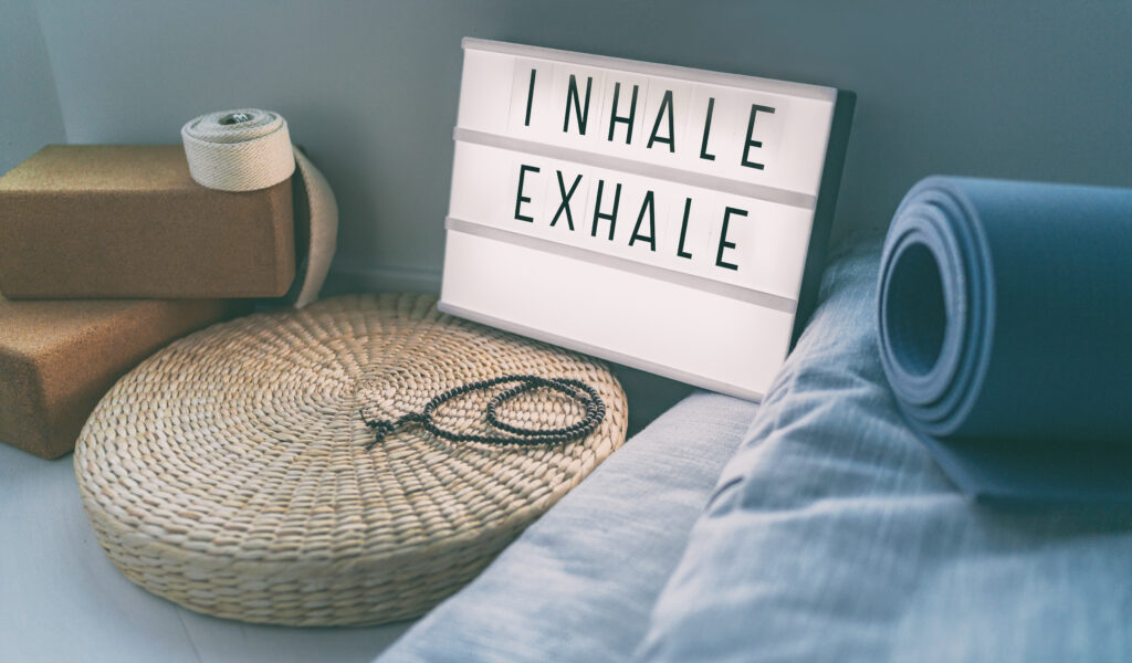 Sign that says Inhale Exhale which represents the importance of doing conscious breathing to help balance the nervous system.  Nervous system dysregulation is caused by PTSD and C-PTSD