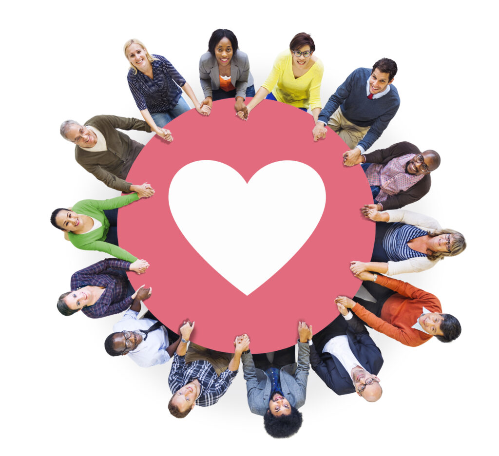 A group of people surrounding a big heart. This represents the importance of connection which in-person therapy provides.  Connection heals complex PTSD